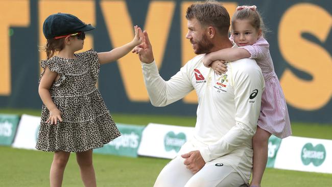 David Warner celebrates with his children after Australia beat England by 251 runs during day five of the first Ashes Test. Picture: AP