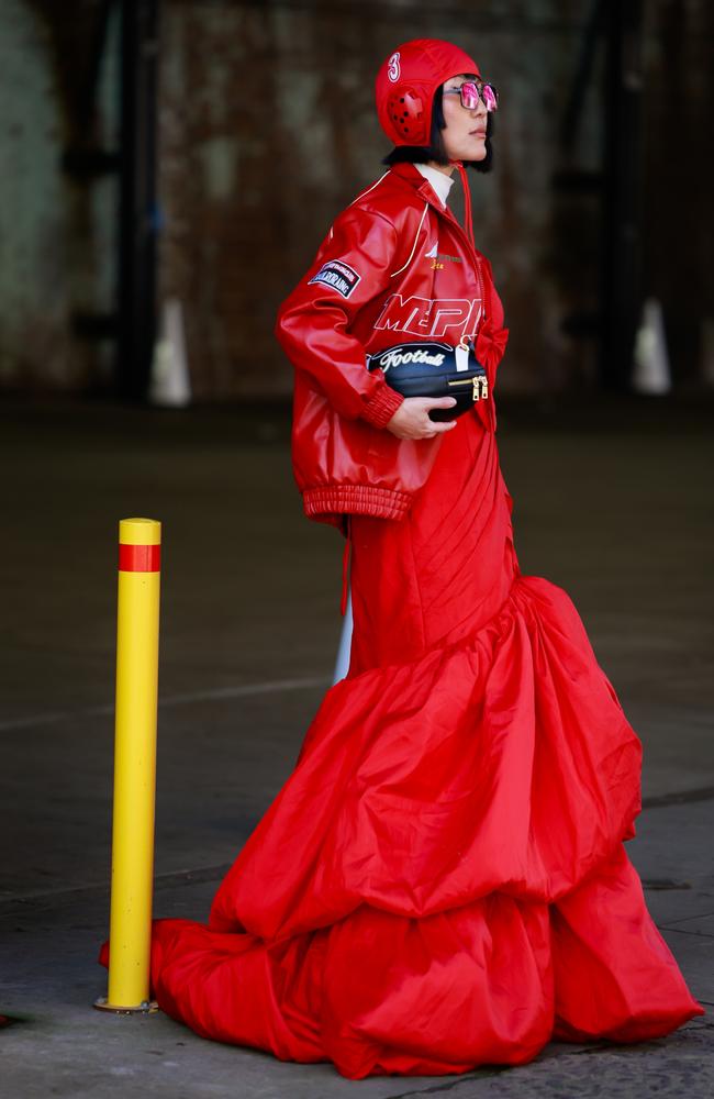 Charlene Davies wearing red TAG Heuer helmet, leather jacket and a ball gown inspired by F1 during Australian Fashion Week. Picture: Hanna Lassen/Getty Images