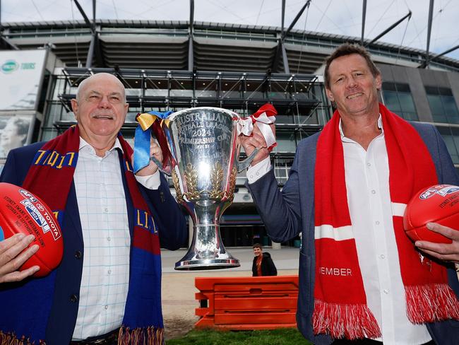 MELBOURNE, AUSTRALIA - SEPTEMBER 26: Premiership cup presenters Leigh Matthews (Brisbane Lions) and Stuart Maxfield (Sydney Swans) pose for a photo during the Premiership Cup Presenters media opportunity at Melbourne Cricket Ground on September 26, 2024 in Melbourne, Australia. (Photo by Dylan Burns/AFL Photos via Getty Images)