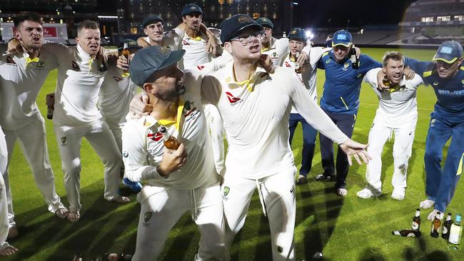 Nathan Lyon and Steve Smith of Australia celebrate with teammates while singing the team song on the pitch after Australia claimed victory to retain the Ashes. Picture: Getty Images