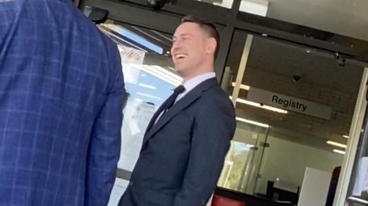 Queensland Health employee Mitchell James Hickman (right) leaves Richlands Magistrates Court with his lawyer.