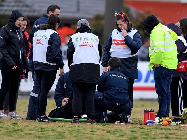 Trainers attend to Kyle Hird. Picture: Andy Brownbill