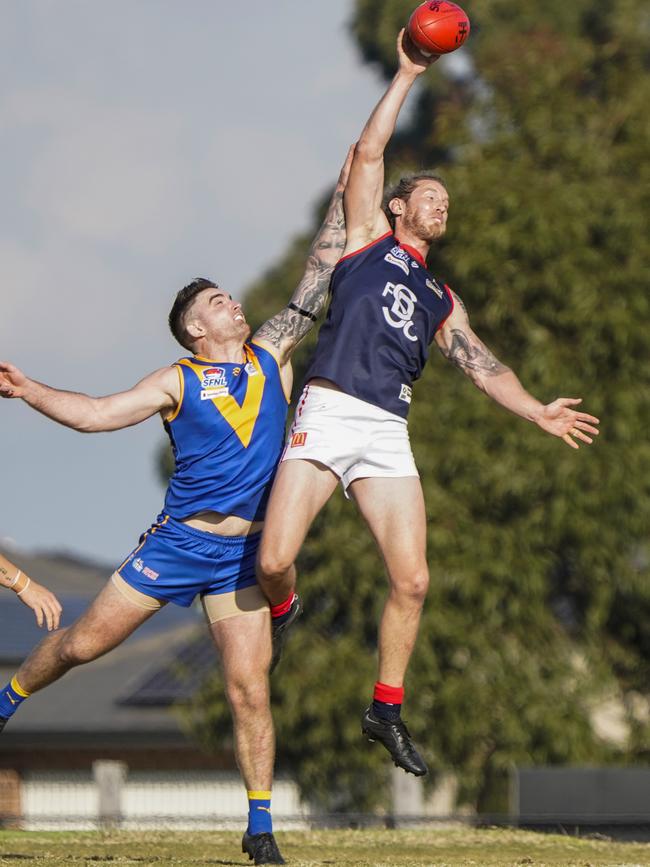 SFNL: Springvale Districts’ Tyrone Vickery jumps over Jake Stephens of Cranbourne. Picture: Valeriu Campan