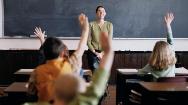 NEWS: Generic pic of a teacher standing at the blackboard while talking to students in a classroom.