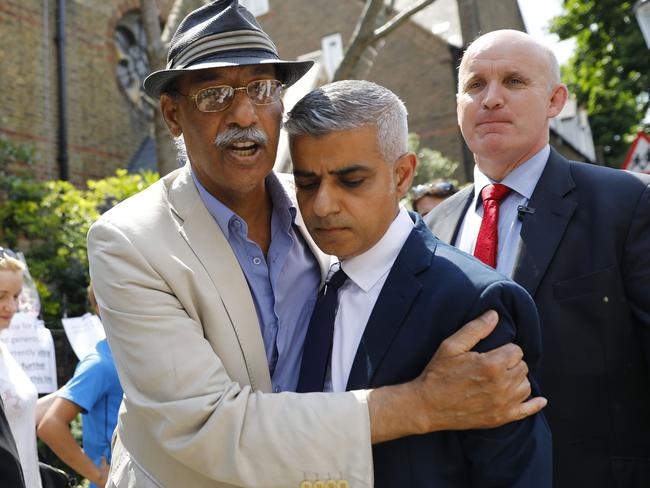 Mayor of London Sadiq Khan (right) is embraced by a parishioner as he leaves St Clement's church in Notting Hill, close to Grenfell Tower. Picture: AFP/Tolga Akmen