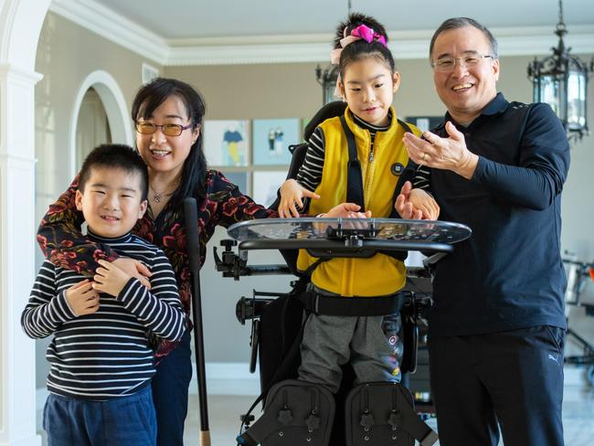 14-year old Yuna (C), the daughter of genetic researchers and neuroscientists Dr Soo-Kyung Lee (L) and Jae Lee (R), was diagnosed FOXG1 Syndrome.  Eldest brother Joon (Far left). The couple are now developing a therapy for the rare condition, and will open the world's first institute dedicated to FOXG1 research at the University of Buffalo in the United States. Picture: Supplied