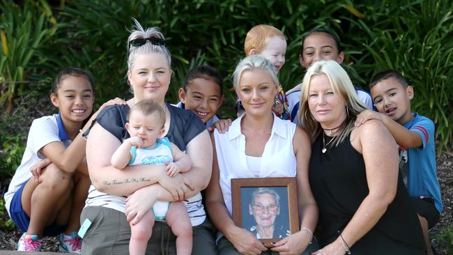 Donna Austin (centre right, black top) with her daughters Melissa Austin (left) and Shalyne Piliae (holding picture) and grandkids holding a pic of their great-grandma Alma Smith, who died in the Quakers Hill nursing home fire. Picture: Adam Taylor