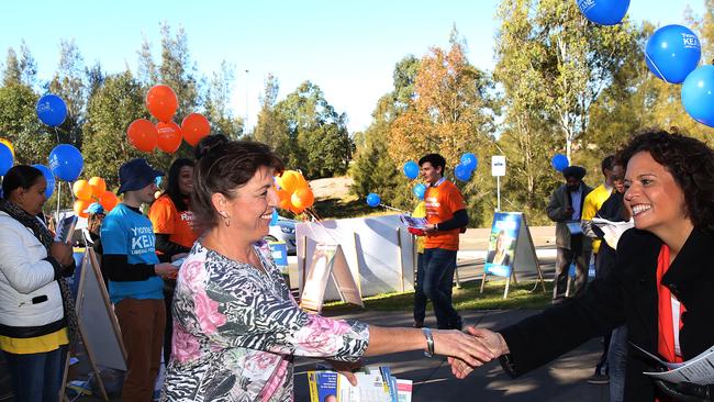 A voter at Kellyville Ridge Public School shake hands with Greenway MP Michelle Rowland on election day.