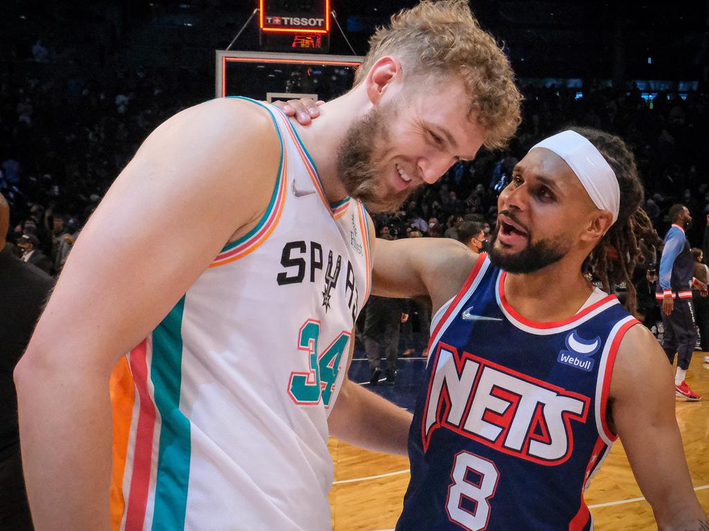 Bronzed Aussies Jock Landale and Patty Mills catch up after playing against each other in the NBA.
