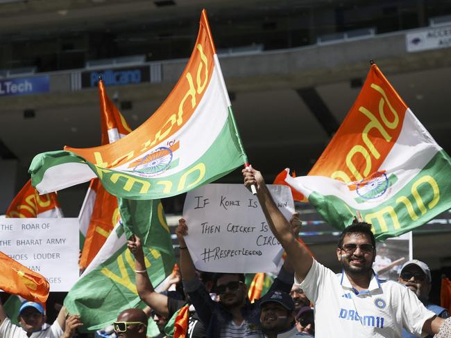 TOPSHOT - Indian supporters cheer for their team on day five of the fourth cricket Test match between Australia and India at the Melbourne Cricket Ground (MCG) in Melbourne on December 30, 2024. (Photo by Martin KEEP / AFP)