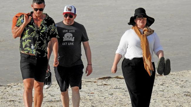 US actor Melissa McCarthy out for a walk along the beach with her actor husband Ben Falcone (centre) and British actor Luke Evans in Byron Bay. Picture: Nathan Edwards.