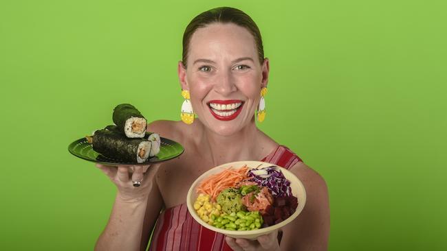 Bree May holding a plate of sushi rolls and a poke bowl. Picture: AAP/ ROY VANDERVEGT