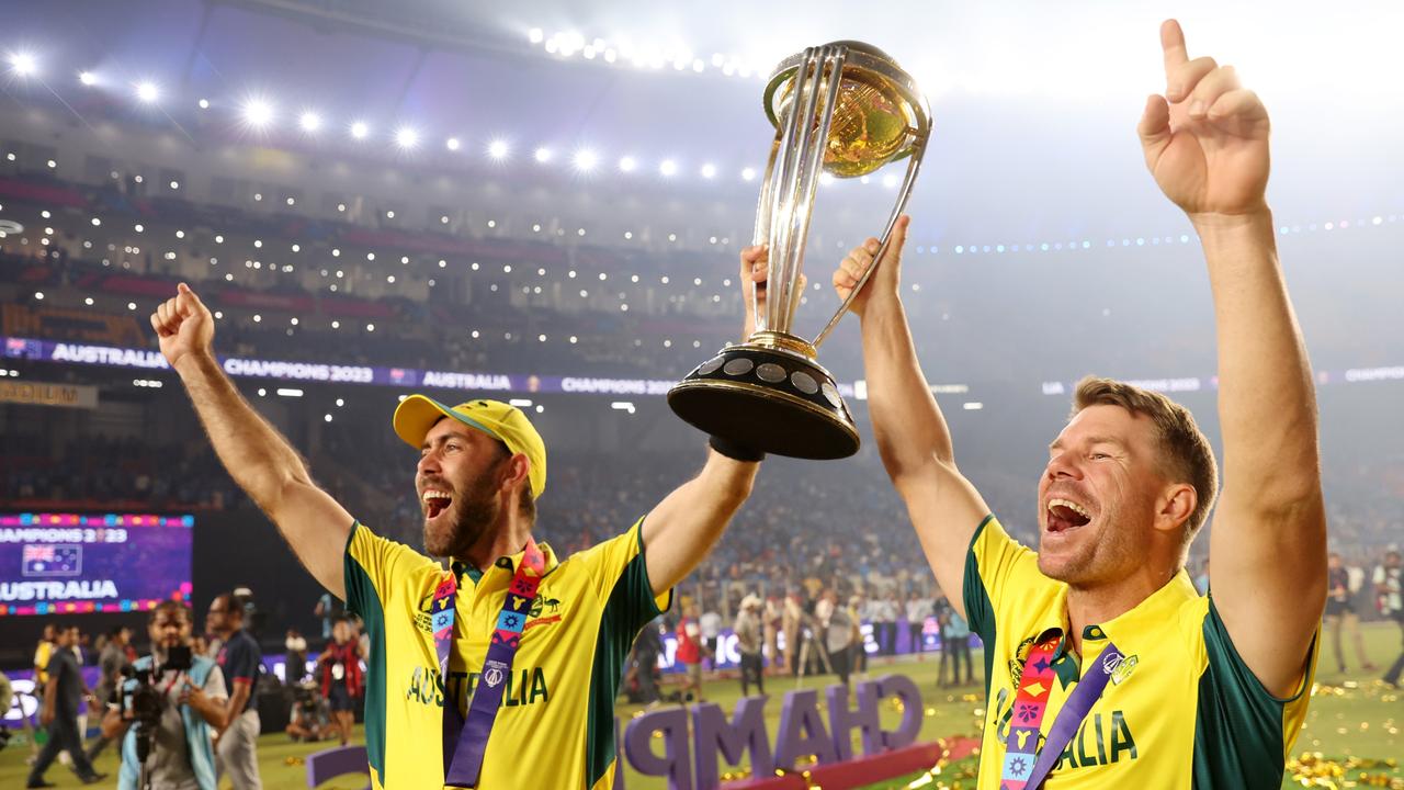 Glenn Maxwell and David Warner celebrate with the World Cup. Picture: AFP