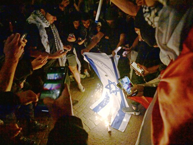 Protesters burn an Israeli flag. Picture: Jeremy Piper/NCA NewsWire