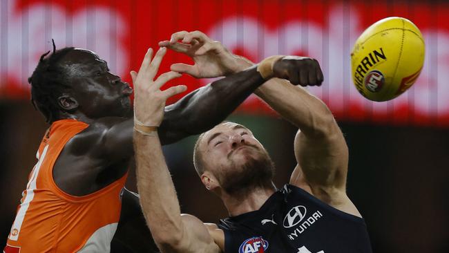 MELBOURNE , AUSTRALIA. April 20 , 2024.  AFL Round 6.  Carlton vs GWS Giants at Marvel Stadium.   Leek Aleer of the Giants punches the ball away from Harry McKay of the Blues    . Pic: Michael Klein