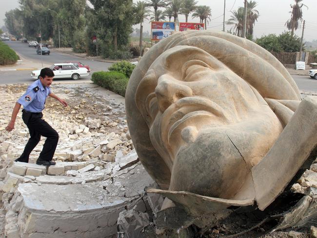 Toppled empire ... An Iraqi policeman approaches the toppled statue of caliph Abu Jaafar Al-Mansour’s statue in Baghdad, in 2005. A bomb destroyed the statue of the caliph who founded Baghdad in the 8th century.