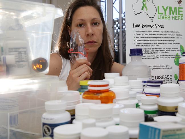 Lisa Gumieniuk with some the medication and equipment she needs for the treatment of Lyme disease. Picture: Craig Wilson