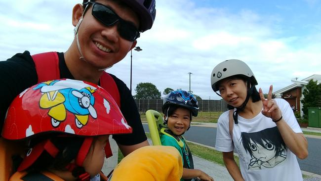 Cyclist commuter Patrick Pramana, with wife Vina, and children Nathaniel and Nikolas, preparing to take a family ride from their Carseldine home.