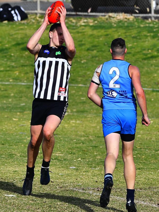 Waikerie’s Daniel Nobes takes a grab at the top of the goal square ahead of a Barmera-Monash opponent. Picture: Grant Schwartzkopff