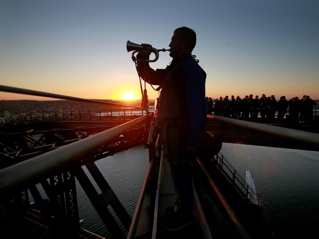 A dawn service was held on the summit of the Sydney Harbour Bridge to commemorate ANZAC Day. Bugler and Leading seaman Marcus Salone plays The Last Post on top of the bridge. Picture: Toby Zerna