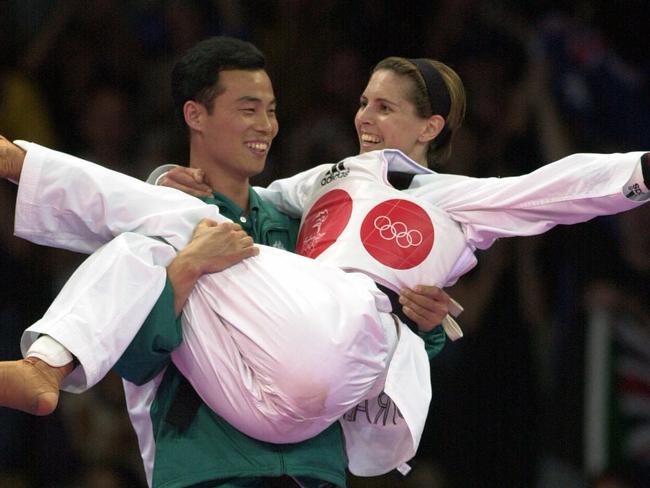 Lauren Burns celebrating with coach Jin Tae Jeong after winning the first ever Olympic taekwondo medal.