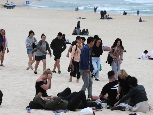 Bondi Beach was packed as people stayed to watch the first sunrise of the year. Picture: Bill Hearne