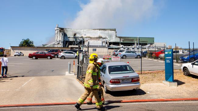 Firefighters on the scene at Thomas Foods abattoir outside Murray Bridge, where the fire continues to burn in a basement. Picture: AAP / James Elsby