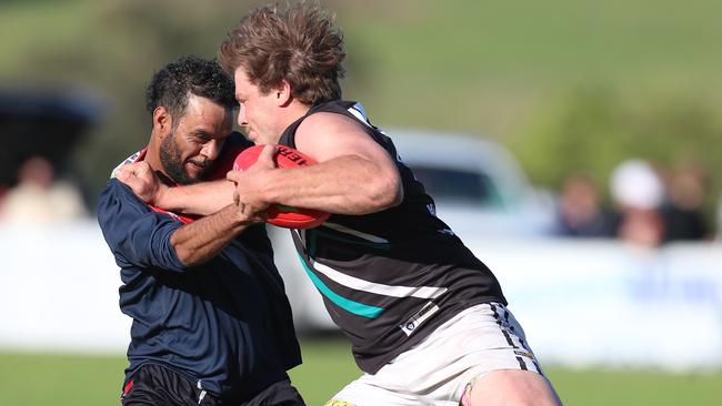 Omeo-Benambra’s Cody Graske tries to fend off Swifts Creek captain Nathan Hayes. Picture: Yuri Kouzmin