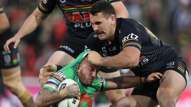 Canberra's Josh Hodgson is tackled by Penrith's Reagan Campbell-Gillard during the Penrith v Canberra NRL match at Panthers Stadium, Penrith. Picture: Brett Costello