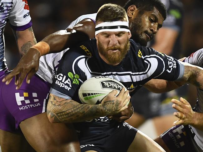 MACKAY, AUSTRALIA - MARCH 02: Josh McGuire of the Cowboys is wrapped up by the Storm defence  during the NRL Trial match between the Melbourne Storm and the North Queensland Cowboys on March 02, 2019 in Mackay, Australia. (Photo by Ian Hitchcock/Getty Images)