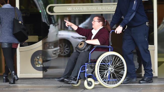 Mark Freer’s wife Kerry Freer, who has MS, is helped to their car by a court sheriff and drove away by herself home after her husband was remanded in custody. Picture: NCA NewsWire / Tricia Watkinson