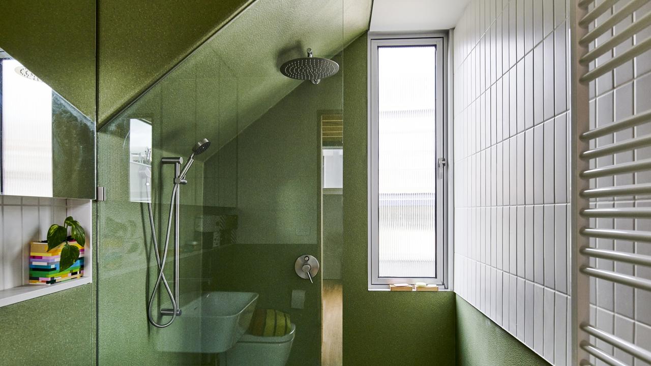 Angled ceilings and vertical windows creates the illusion of a bigger space in the bathroom.