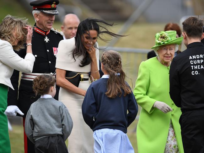 Meghan, Duchess of Sussex, speaks to a girl in the town of Widnes in Halton, Cheshire, England. Picture: Getty