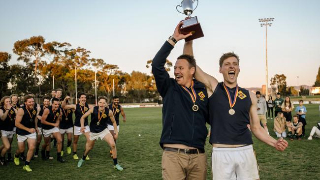 Cobb and captain Lachlan Giles lift the trophy after Scotch defeated Seaton Ramblers to win the 2018 division three grand final. Picture: AAP/Morgan Sette