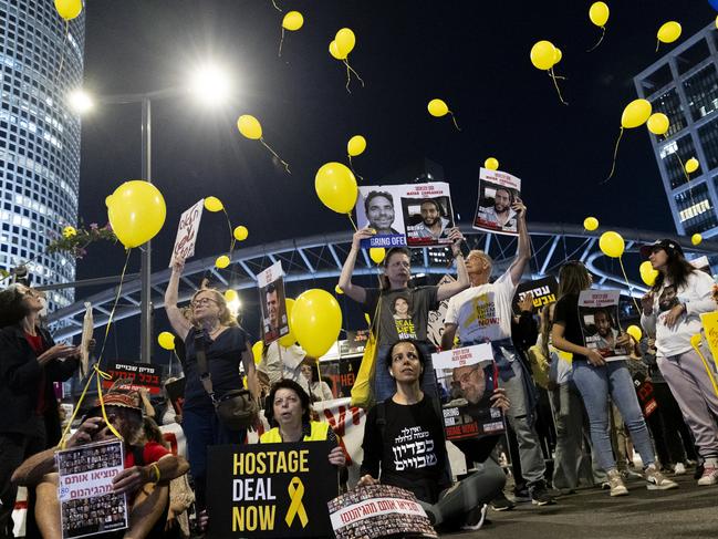 TEL AVIV, ISRAEL - APRIL 03: Families of hostages held in the Gaza Strip and supporters hold signs and photos of hostages, as they are releasing yellow balloons during a demonstration calling for a hostage deal on April 03, 2024 in Tel Aviv, Israel. Israelis' frustrations with the government led by Benjamin Netanyahu have persisted as over 100 hostages remain captive in Gaza, after nearly six months of war between Israel and Hamas, the Palestinian militant group that attacked Israel on Oct. 7. (Photo by Amir Levy/Getty Images)