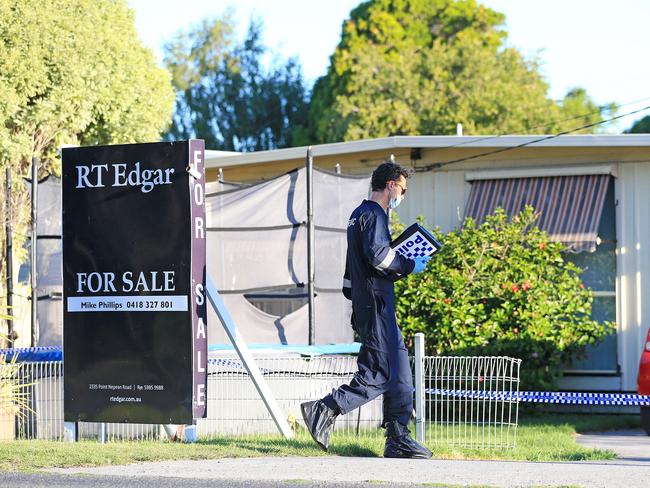 A detective walks into the house, which is for sale. Picture: Mark Stewart