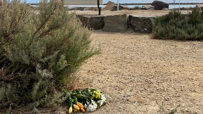 Flowers left near the scene at Lady Ruthven Reserve on Tuesday. Picture: RoyVphotography