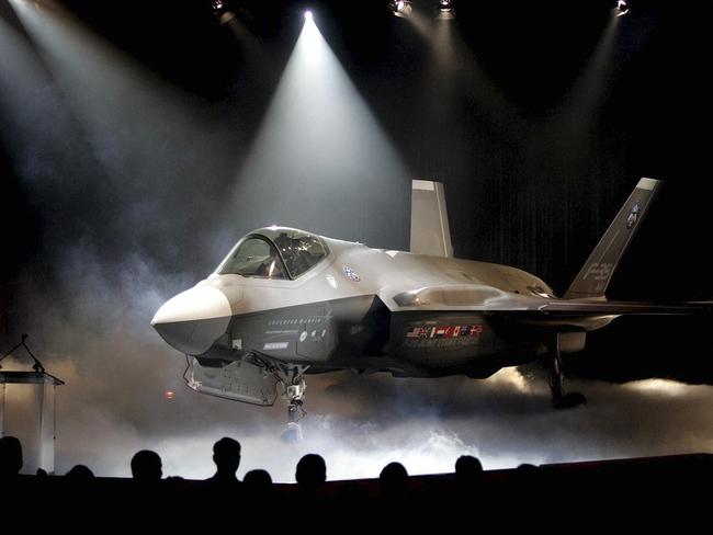 FILE - In this July 7, 2006, file photo, the Lockheed Martin F-35 Joint Strike Fighter is shown after it was unveiled in a ceremony in Fort Worth, Texas. Shares of Lockheed Martin fell Monday, Dec. 12, 2016, as President-elect Donald Trump tweeted that making F-35 fighter planes is too costly and that he will cut "billions" in costs for military purchases. (AP Photo/LM Otero, File)