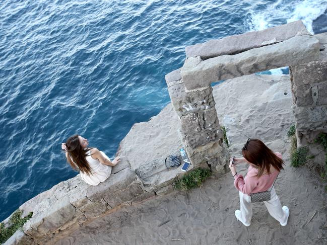 The tourists take enormous risks for the perfect photo. Picture by Damian Shaw