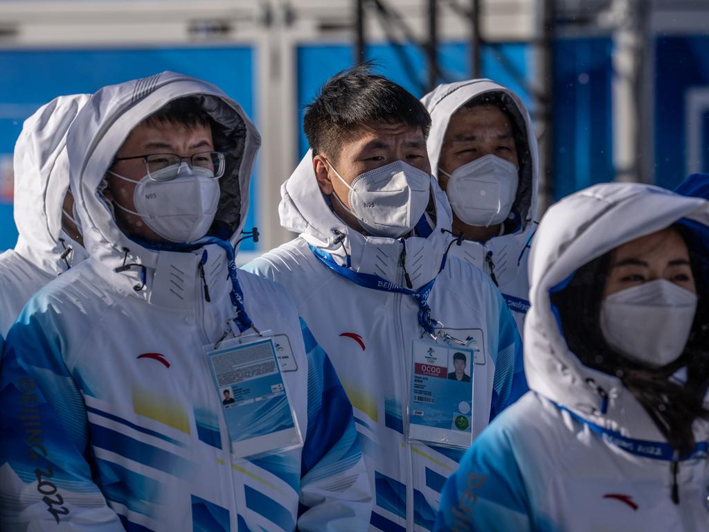 Winter Olympics volunteers listen to a briefing at the medal plaza in Zhangjiakou Olympic village. Picture: Getty Images