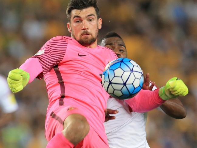 Mathew Ryan of the Socceroos clears the ball as Ismail Al Hammadi closes in  from  during the Socceroos v United Arab Emirates World Cup qualifier at Allianz Stadium, Sydney. pic Mark Evans