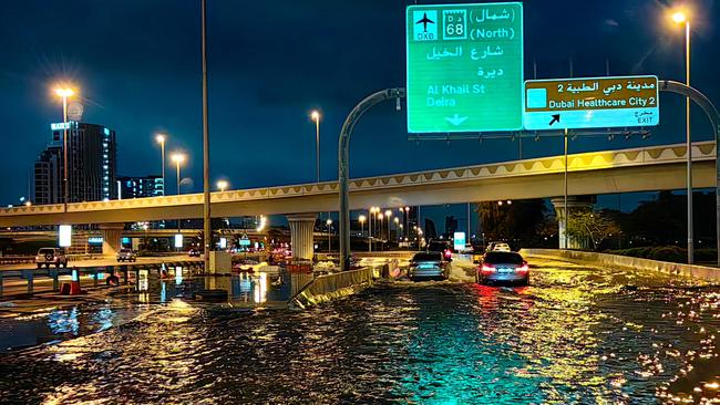 Motorists drive along a flooded street following heavy rains in Dubai. Picture: Giuseppe CACACE/AFP