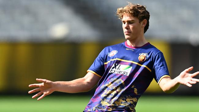 Deven Robertson warms up before his AFL debut for Brisbane in Round 1.