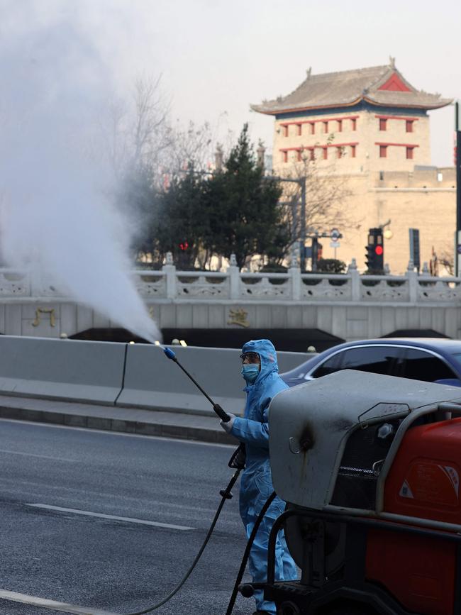 Spraying disinfectant on street in Xi'an in China's northern Shaanxi province. Picture: AFP