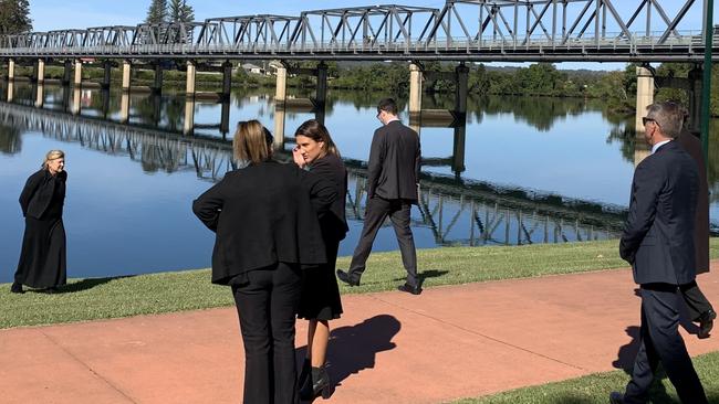 Magistrate Erin Kennedy turns back as the other parties go down to the Manning River edge on the first day of the inquest into the death of Brandon Clark, who drowned in January last year. Picture: Janine Watson