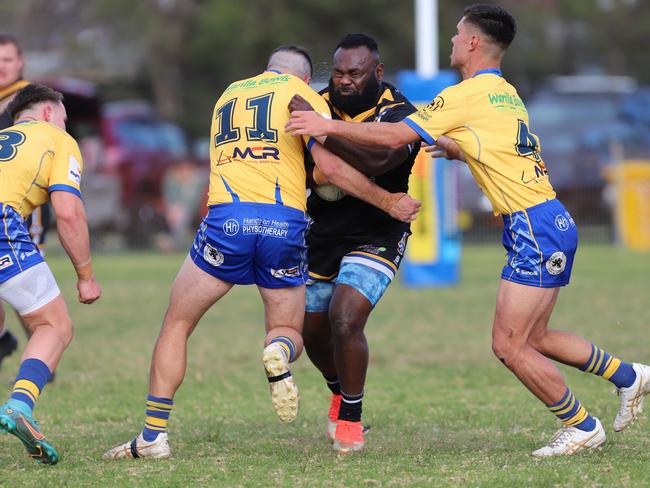 Matori Atunaisa is hit by Jamie Burns (left) and Darnell Walker. Picture: Steve Montgomery/Ourfootyteam