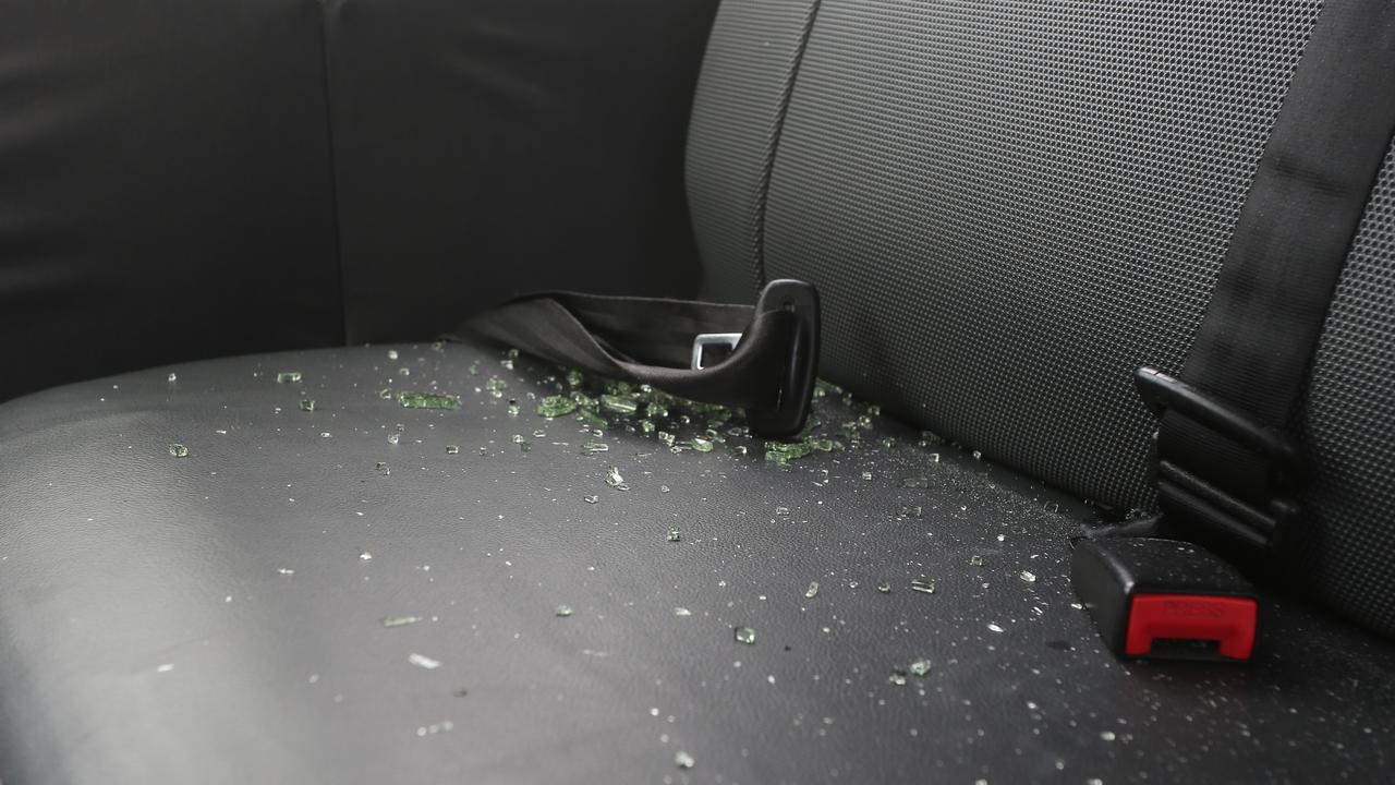 Broken glass was scattered across the floor and seats of the taxi. Picture: Peter Carruthers