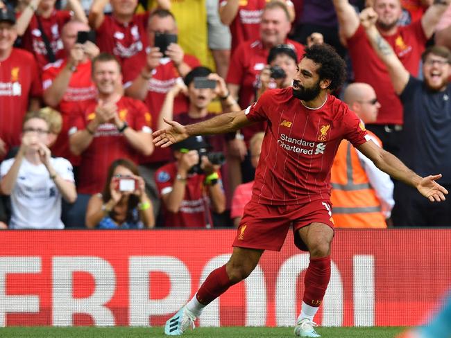 Liverpool's Egyptian midfielder Mohamed Salah celebrates after scoring his second goal, Liverpool's third during the English Premier League football match between Liverpool and Arsenal at Anfield in Liverpool, north west England on August 24, 2019. (Photo by Ben STANSALL / AFP) / RESTRICTED TO EDITORIAL USE. No use with unauthorized audio, video, data, fixture lists, club/league logos or 'live' services. Online in-match use limited to 120 images. An additional 40 images may be used in extra time. No video emulation. Social media in-match use limited to 120 images. An additional 40 images may be used in extra time. No use in betting publications, games or single club/league/player publications. /