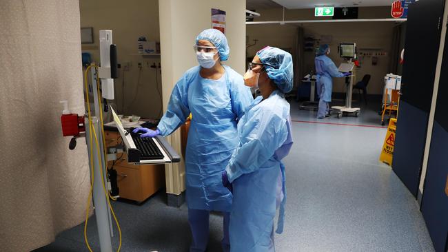 Nurses Britney Avery and Judy Lou, in the Red Covid-19 ICU at Royal Prince Alfred Hospital. Picture Rohan Kelly