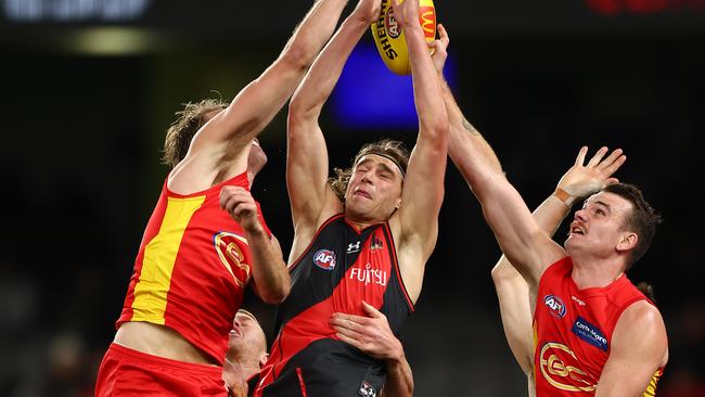 Harrison Jones outmarks two Gold Coast defenders. Picture: Graham Denholm/AFL Photos via Getty Images